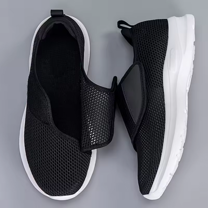 Schwarze Mesh-Sneaker mit weißer Sohle, Klettverschluss, atmungsaktivem Design, ideal für Sport und Freizeit. Bequeme, moderne Sportschuhe.