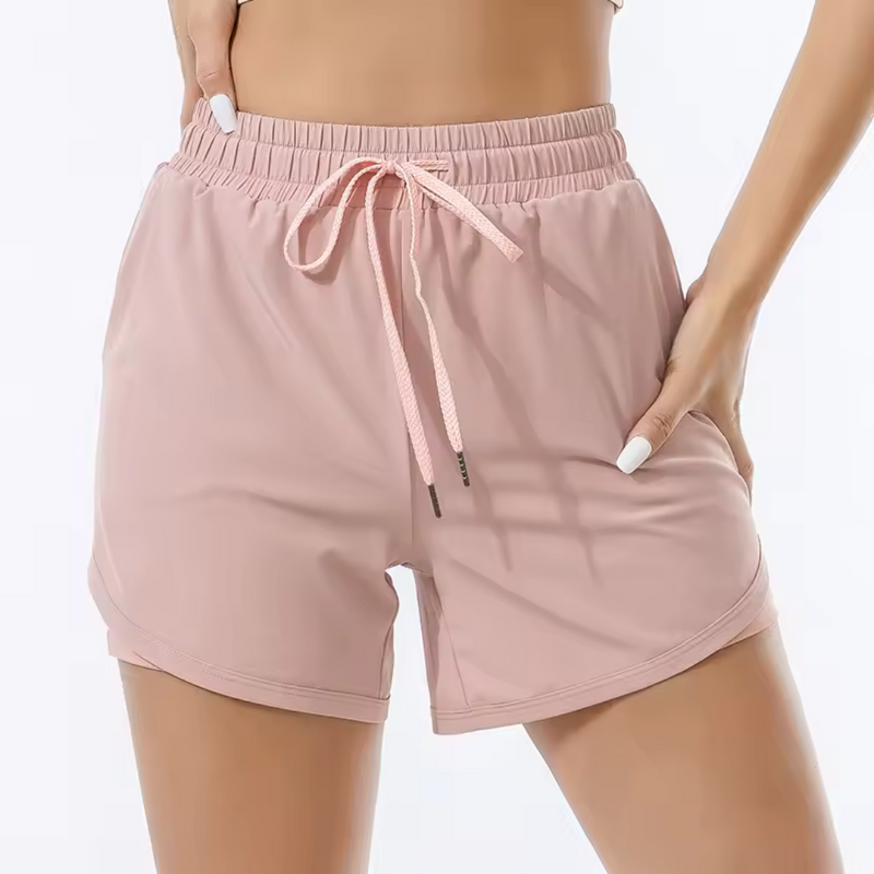 Laden Sie das Bild in Galerie -Viewer, Damen-Sportshorts in Rosa, elastischer Bund mit Kordelzug, atmungsaktives Material, ideal für Fitness und Laufen.
