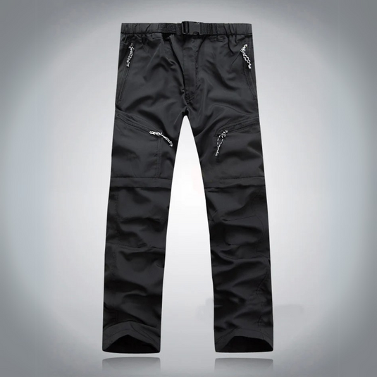 Schwarze Outdoor-Hose mit mehreren Reißverschlusstaschen, strapazierfähigem Material und verstellbarem Bund, ideal für Wandern und Trekking.