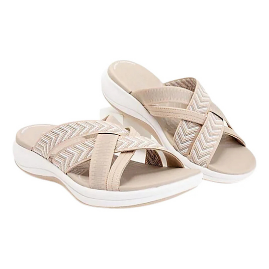 Beige Damen-Sandalen mit überkreuzten Riemen und Chevron-Muster, bequeme flache Sohle, ideal für Sommermode und Freizeitkleidung.