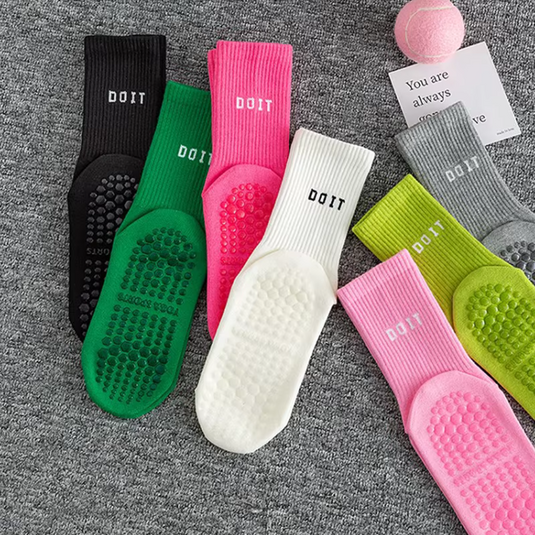 Bunte rutschfeste Sportsocken auf grauem Teppich, mit Text 