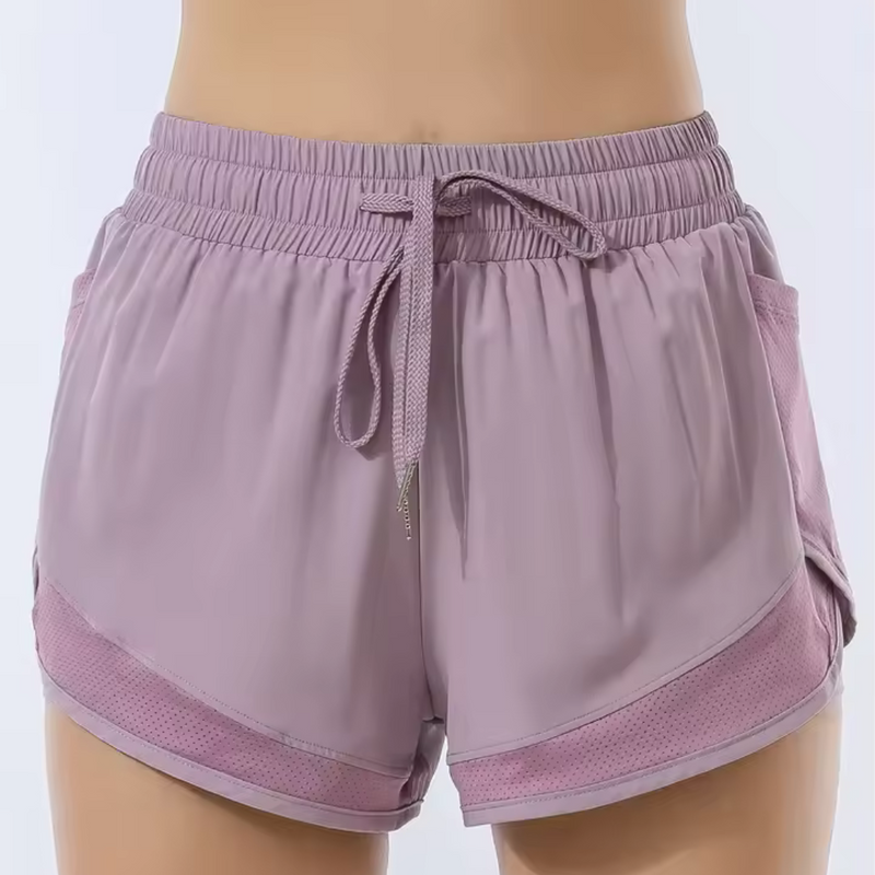 Laden Sie das Bild in Galerie -Viewer, Damen Sportshorts in Lila mit elastischem Bund und Kordelzug, atmungsaktivem Material, ideal für Fitness und Laufen.
