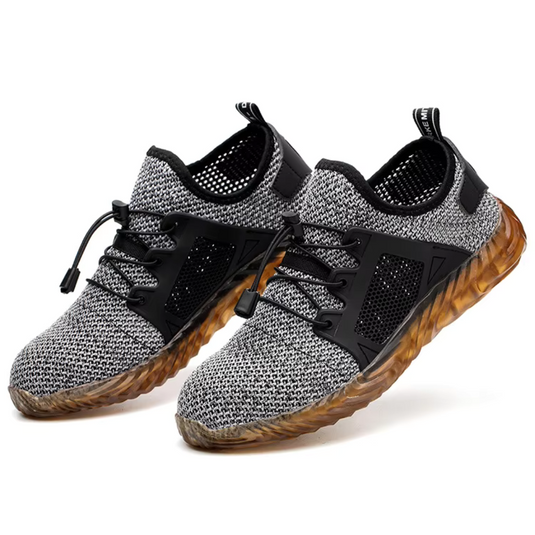 Graue Sportschuhe mit atmungsaktivem Mesh-Obermaterial und brauner, rutschfester Sohle. Ideal für Laufen und Fitness. Herren Sneaker modern.