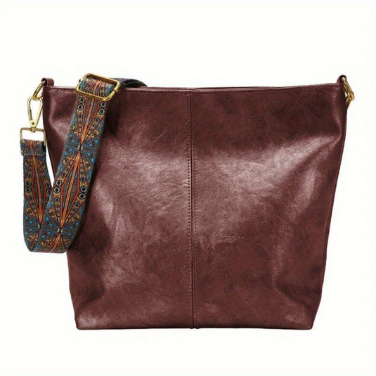 Braune Ledertasche mit verziertem, abnehmbarem Schultergurt. Modische Damenhandtasche, ideal für Alltag und Büro. Hochwertiges Accessoire.