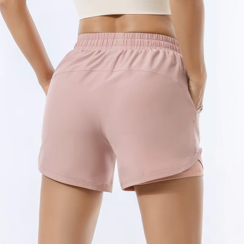 Laden Sie das Bild in Galerie -Viewer, Damen-Sportshorts in Rosa, elastischer Bund, atmungsaktives Material, ideal für Fitness und Laufen. Bequeme Passform, modisches Design.
