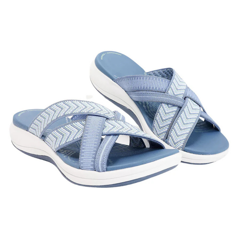 Laden Sie das Bild in Galerie -Viewer, Blaue Damen-Sandalen mit überkreuzten Riemen und weißer Sohle, ideal für Sommermode und bequeme Freizeitkleidung.
