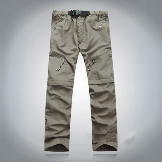 Graue Outdoor-Hose mit Reißverschlusstaschen und Gürtel, ideal für Wandern und Trekking. Robustes Material, funktionales Design.
