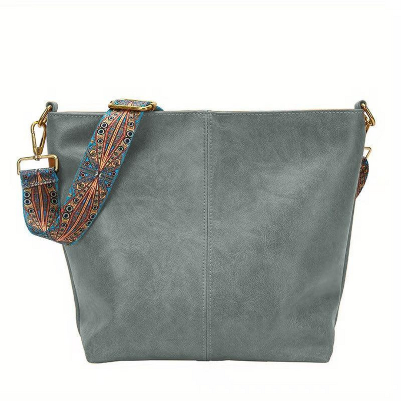 Laden Sie das Bild in Galerie -Viewer, Graue Damenhandtasche aus Leder mit verstellbarem, gemustertem Schultergurt. Modische Umhängetasche, ideal für Alltag und Freizeit.

